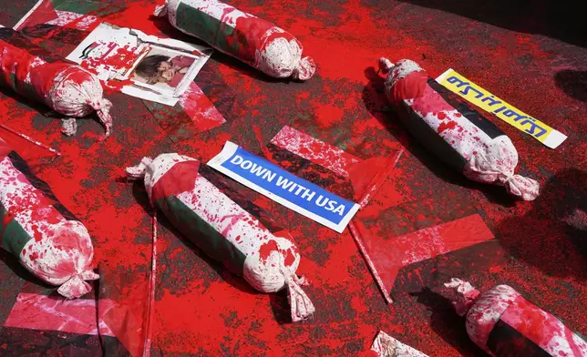 The symbolic shrouded bodies of Palestinian children are displayed during an anti-Israel demonstration at the Felestin (Palestine) Sq. in Tehran, Iran, Wednesday, April 9, 2025. (AP Photo/Vahid Salemi)