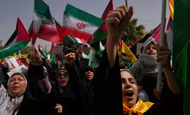 Iranian protesters chant slogans as they wave Palestinian and their country's flags during an anti-Israeli demonstration at the Felestin (Palestine) Sq. in Tehran, Iran, Wednesday, April 9, 2025. (AP Photo/Vahid Salemi)