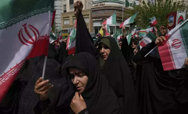 Iranian protesters chant slogans as they wave their country's flags during an anti-Israel demonstration at the Felestin (Palestine) Sq. in Tehran, Iran, Wednesday, April 9, 2025. (AP Photo/Vahid Salemi)