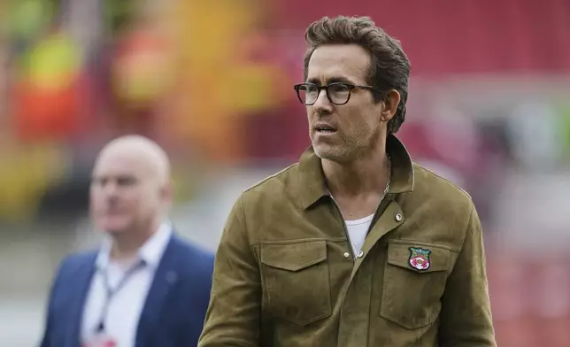 Wrexham co-owners Ryan Reynolds walks on the field before the English League One soccer match between Wrexham and Charlton Athletic at the Racecourse ground in Wrexham, Wales, Saturday, April 26, 2025. (AP Photo/Jon Super)