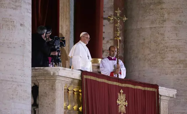 FILE - Argentine Cardinal Jorge Bergoglio, who chose the name of Pope Francis, looks out to the crowd from the central balcony of St. Peter's Basilica after being elected 266th pontiff of the Roman Catholic Church, at the Vatican, Wednesday, March 13, 2013. (AP Photo/Luca Bruno, file)