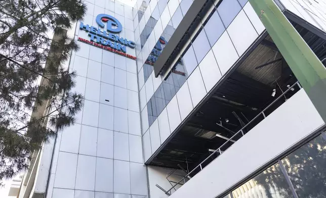 The logo of Hellenic Train, Greece's main railway company, is seen outside company's headquarters, following a bomb explosion Friday night causing causing limited damage but no injuries, in Athens, Greece, on Saturday, April 12, 2025. (AP Photo/Yorgos Karahalis)