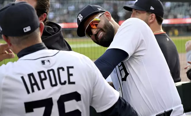 Detroit Tigers left fielder Riley Greene (31) jokes around in the dugout with first base coach Anthony Iapoce (76) before a baseball game against the San Diego Padres, Tuesday, April 22, 2025, in Detroit. (AP Photo/Lon Horwedel)