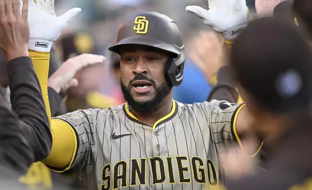 San Diego Padres catcher Elias Díaz (17) celebrates in the dugout after hitting a two-run home run off Detroit Tigers' Jack Flaherty, not pictured, during the second inning of a baseball game, Tuesday, April 22, 2025, in Detroit. (AP Photo/Lon Horwedel)