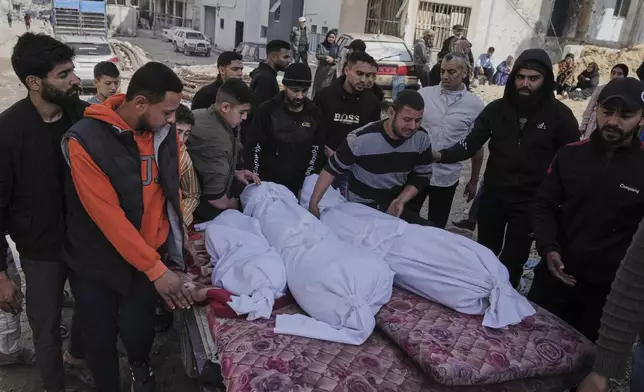 Palestinians accompany the bodies of their relatives killed in an Israeli airstrike, loaded onto a carte in preparation for burial, at Shifa Hospital in Gaza City, Wednesday, April 16, 2025. (AP Photo/Jehad Alshrafi)