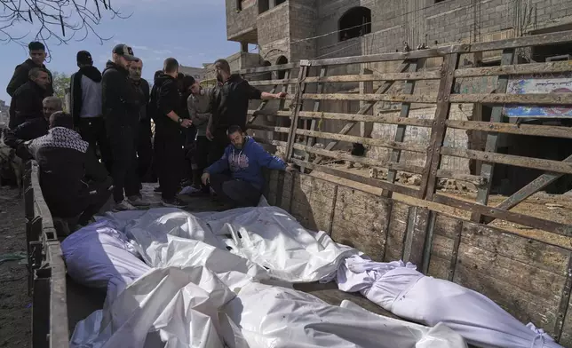 Palestinians accompany the bodies of their relatives killed in an Israeli airstrike, loaded onto a truck in preparation for burial, at Shifa Hospital in Gaza City, Wednesday, April 16, 2025. (AP Photo/Jehad Alshrafi)