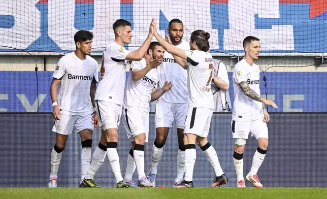 Leverkusen's Emiliano Buendia (3rd from left) celebrates scoring during the German Bundesliga soccer match between 1. FC Heidenheim and Bayer Leverkusen, at the Voith-Arena in Heidenheim, Germany, Saturday, April 5, 2025. (Harry Langer/dpa via AP)