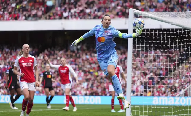 Lyon goalkeeper Christiane Endler leaps for a save during the women's Champions League semifinals, first leg, soccer match between Arsenal FC and Olympique Lyonnais at the Arsenal Stadium, in London, Saturday, April 19, 2025. (AP Photo/Kirsty Wigglesworth)