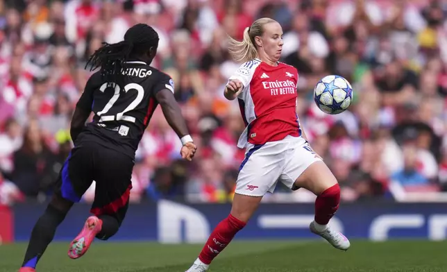 Arsenal's Beth Mead controls the ball next to Lyon's Tabitha Chawinga, left, during the women's Champions League semifinals, first leg, soccer match between Arsenal FC and Olympique Lyonnais at the Arsenal Stadium, in London, Saturday, April 19, 2025. (AP Photo/Kirsty Wigglesworth)