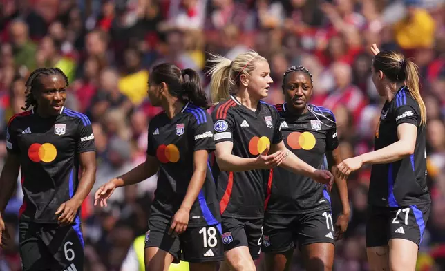 Lyon's Melchie Dumornay, Alice Sombath, Lindsey Heaps, Kadidiatou Diani and Vanessa Gilles, from left, react after Diani scored the opening goal during the women's Champions League semifinals, first leg, soccer match between Arsenal FC and Olympique Lyonnais at the Arsenal Stadium, in London, Saturday, April 19, 2025. (AP Photo/Kirsty Wigglesworth)