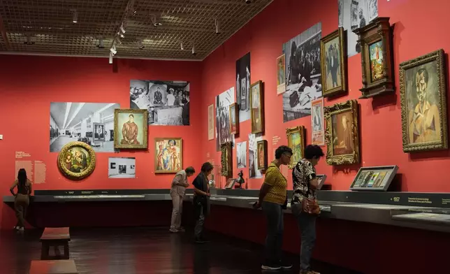 Visitors view an exhibition at the Sao Paulo Art Museum or MASP, in Sao Paulo, Thursday, April 10, 2025. (AP Photo/Andre Penner)
