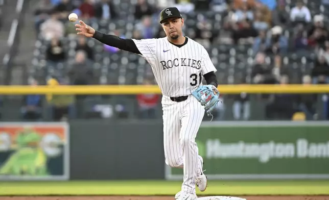 Colorado Rockies shortstop Alan Trejo (31) throws to first base for the first out of the third inning of a baseball game against the Atlanta Braves Tuesday, April 29, 2025, in Denver. (AP Photo/Geneva Heffernan)
