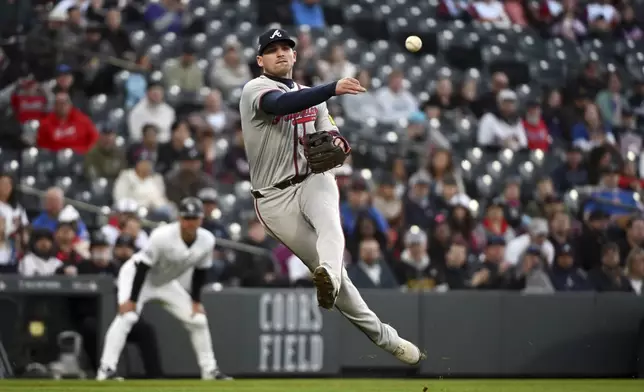 Atlanta Braves third baseman Austin Riley (27) throws to first base for an out in the third inning of a baseball game against the Colorado Rockies, Tuesday, April 29, 2025, in Denver. (AP Photo/Geneva Heffernan)
