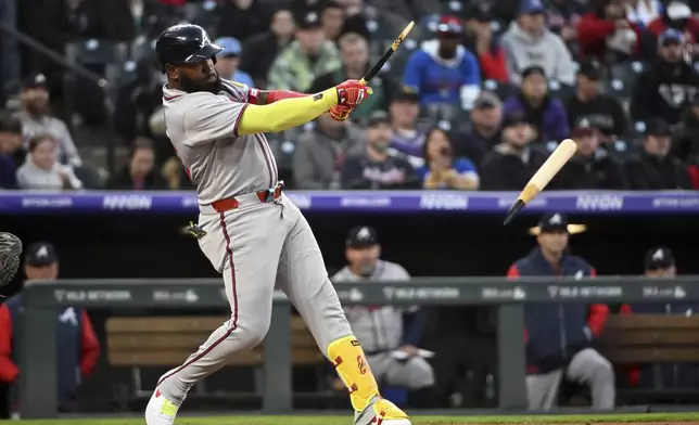 Atlanta Braves designated hitter Marcell Ozuna (20) breaks his bat on a pitch in the fifth inning of a baseball game against the Colorado Rockies, Tuesday, April 29, 2025, in Denver. (AP Photo/Geneva Heffernan)