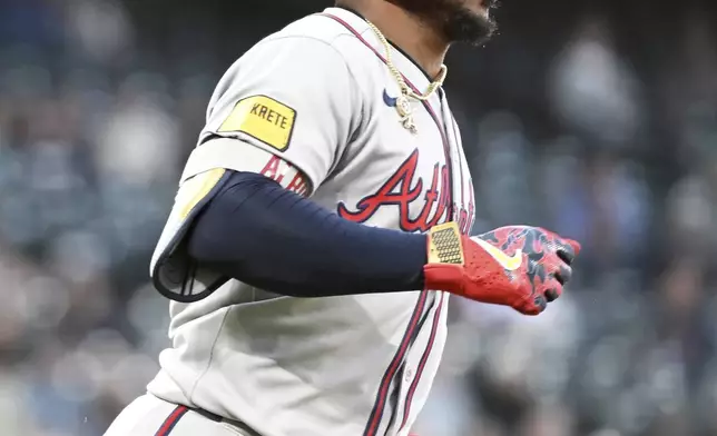 Atlanta Braves' Ozzie Albies (1) runs to second base after a fielding error by Colorado Rockies right fielder Mickey Moniak (22) in the fifth inning of a baseball game Tuesday, April 29, 2025, in Denver. (AP Photo/Geneva Heffernan)