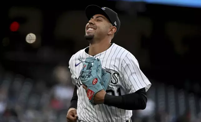 Colorado Rockies shortstop Alan Trejo (31) smiles after fielding three outs in the third inning of a baseball game against the Atlanta Braves Tuesday, April 29, 2025, in Denver. (AP Photo/Geneva Heffernan)