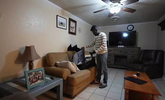 Haitian immigrant Kevenson Jean, a truck driver, packs for road trip, Tuesday, April 15, 2025, in Panhandle, Texas. (AP Photo/Eric Gay)