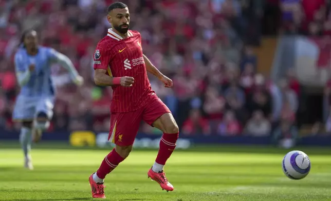 Liverpool's Mohamed Salah chases the ball during the English Premier League soccer match between Liverpool and Tottenham Hotspur at Anfield in Liverpool, England, Sunday, April 27, 2025. (AP Photo/Jon Super)