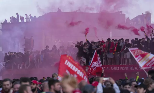 Liverpool supporters celebrate outside of Anfield stadium after their team won English Premier League soccer match against Tottenham Hotspur and clinched the Premier League title in Liverpool, England, Sunday, April 27, 2025. (AP Photo/Jon Super)