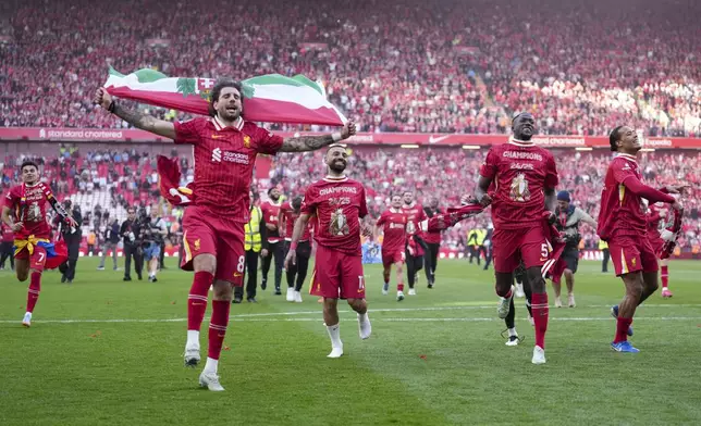 Liverpool's Dominik Szoboszlai celebrates with teammates after winning the English Premier League soccer match between Liverpool and Tottenham Hotspur and clinching the Premier League title at Anfield in Liverpool, England, Sunday, April 27, 2025. (AP Photo/Jon Super)