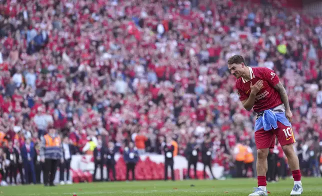 Liverpool's Alexis Mac Allister celebrates with teammates after winning the English Premier League soccer match between Liverpool and Tottenham Hotspur and clinching the Premier League title at Anfield in Liverpool, England, Sunday, April 27, 2025. (AP Photo/Jon Super)