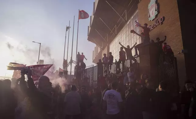 Liverpool supporters celebrate outside of Anfield stadium after their team won English Premier League soccer match against Tottenham Hotspur and clinched the Premier League title in Liverpool, England, Sunday, April 27, 2025. (AP Photo/Jon Super)
