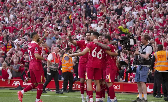 Liverpool's Alexis Mac Allister, right, celebrates with teammates after scoring his side's second goal during the English Premier League soccer match between Liverpool and Tottenham Hotspur at Anfield in Liverpool, England, Sunday, April 27, 2025. (AP Photo/Jon Super)