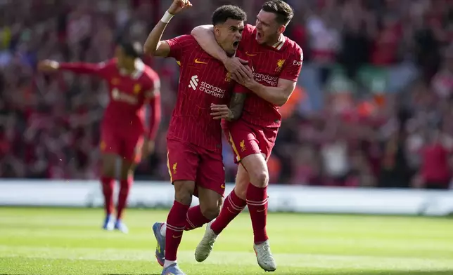 Liverpool's Luis Diaz, left, celebrates with Liverpool's Andrew Robertson after scoring his side's first goal during the English Premier League soccer match between Liverpool and Tottenham Hotspur at Anfield in Liverpool, England, Sunday, April 27, 2025. (AP Photo/Jon Super)