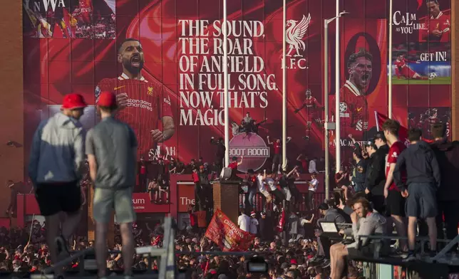 Liverpool supporters celebrate outside of Anfield stadium after their team won English Premier League soccer match against Tottenham Hotspur and clinched the Premier League title in Liverpool, England, Sunday, April 27, 2025. (AP Photo/Jon Super)