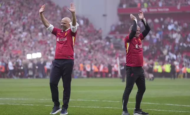 Liverpool's manager Arne Slot, left, celebrates after winning the English Premier League soccer match between Liverpool and Tottenham Hotspur and clinching the Premier League title at Anfield in Liverpool, England, Sunday, April 27, 2025. (AP Photo/Jon Super)