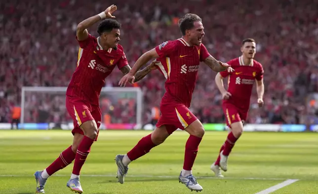Liverpool's Alexis Mac Allister, right, celebrates with Luis Diaz, left, after scoring his side's second goal during the English Premier League soccer match between Liverpool and Tottenham Hotspur at Anfield in Liverpool, England, Sunday, April 27, 2025. (AP Photo/Jon Super)