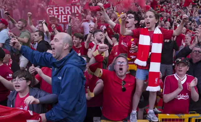 Liverpool supporters celebrate after their team won the English Premier League soccer match between Liverpool and Tottenham Hotspur and clinched the Premier League title at Anfield in Liverpool, England, Sunday, April 27, 2025. (AP Photo/Jon Super)