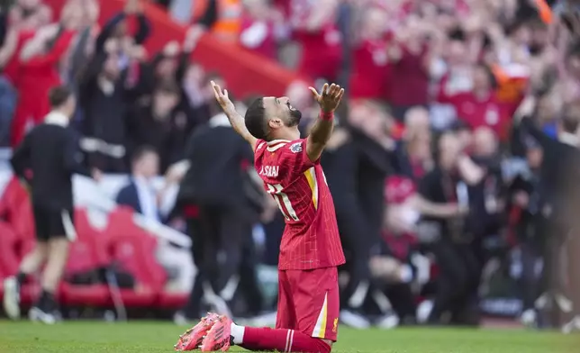 Liverpool's Mohamed Salah celebrates after winning the English Premier League soccer match between Liverpool and Tottenham Hotspur and clinching the Premier League title at Anfield in Liverpool, England, Sunday, April 27, 2025. (AP Photo/Jon Super)