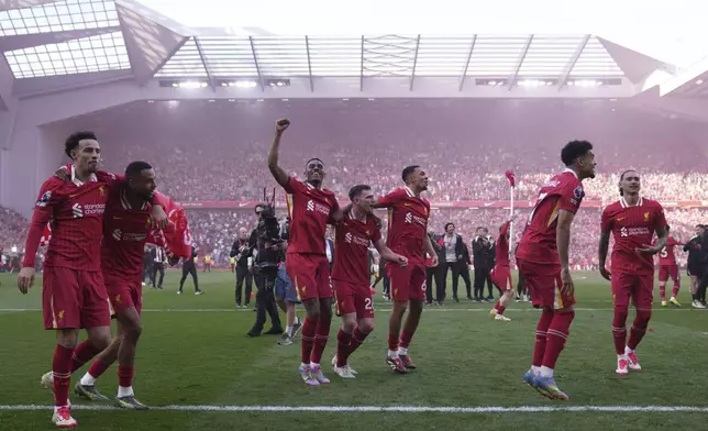 Liverpool players celebrate after winning the English Premier League soccer match between Liverpool and Tottenham Hotspur and clinching the Premier League title at Anfield in Liverpool, England, Sunday, April 27, 2025. (AP Photo/Jon Super)