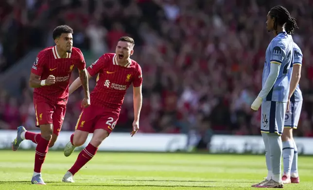 Liverpool's Luis Diaz, left, celebrates with Liverpool's Andrew Robertson after scoring his side's first goal during the English Premier League soccer match between Liverpool and Tottenham Hotspur at Anfield in Liverpool, England, Sunday, April 27, 2025. (AP Photo/Jon Super)