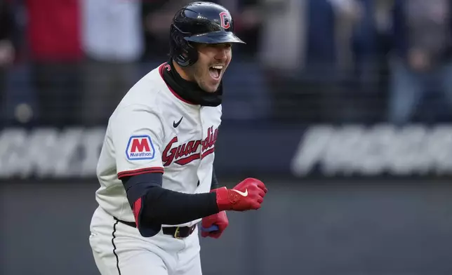 Cleveland Guardians' Nolan Jones celebrates as he runs to first base with a walk in the ninth inning of a baseball game against the Chicago White Sox, brining in the winning run, in Cleveland, Tuesday, April 8, 2025. (AP Photo/Sue Ogrocki)