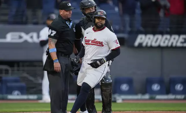 Cleveland Guardians' Carlos Santana scores in front of Chicago White Sox catcher Matt Thaiss on a walk by Nolan Jones in the ninth inning of a baseball game in Cleveland, Tuesday, April 8, 2025. (AP Photo/Sue Ogrocki)