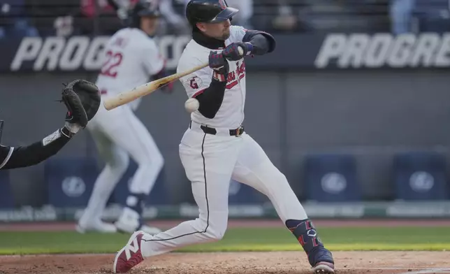Cleveland Guardians' Lane Thomas is hit by a pitch in the fifth inning of a baseball game against the Chicago White Sox in Cleveland, Tuesday, April 8, 2025. (AP Photo/Sue Ogrocki)