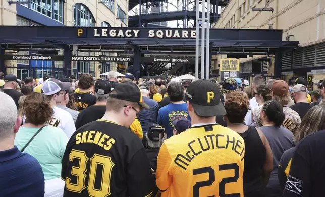 Fans line up outside PNC Park for a baseball game between the Pittsburgh Pirates and the Cleveland Guardians with Pirates' Paul Skenes pitching and having his bobblehead distributed in Pittsburgh, Saturday, April 19, 2025. (AP Photo/Gene J. Puskar)