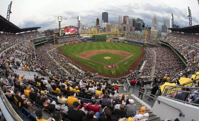 Fans watch a baseball game between the Pittsburgh Pirates and the Cleveland Guardians with Pirates' Paul Skenes pitching on Paul Skenes Bobblehead Day at PNC Park in Pittsburgh, Saturday, April 19, 2025. (AP Photo/Gene J. Puskar)