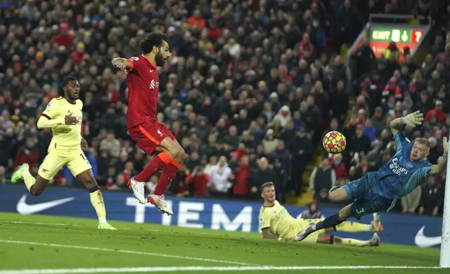 FILE - Liverpool's Mohamed Salah scores his side's third goal during the English Premier League soccer match between Liverpool and Arsenal at Anfield Stadium, Liverpool, England, on Nov. 20, 2021. (AP Photo/Jon Super, File)