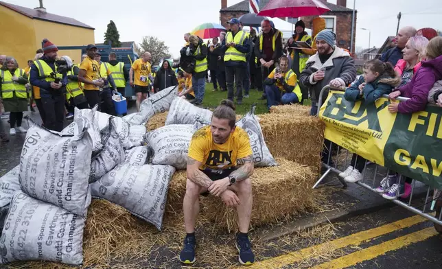 A contestant reacts after competing in the World Coal Carrying Championships in Ossett, West Yorkshire, England, Monday, April 21, 2025. (AP Photo/Jon Super)