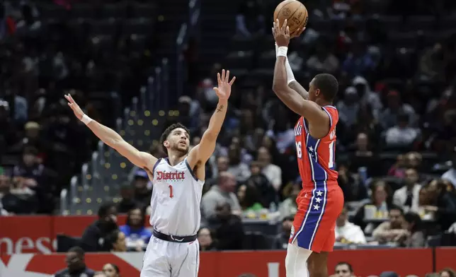 Philadelphia 76ers guard Lonnie Walker IV shoots the ball over Washington Wizards guard Colby Jones (1) during an NBA basketball game in Washington, Wednesday, April 9, 2025. (AP Photo/Terrance Williams)