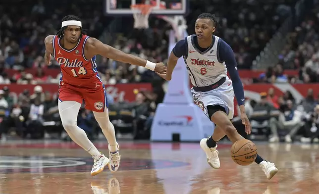 Washington Wizards guard Bub Carrington (8) drives to the basket against Philadelphia 76ers guard Ricky Council IV during the first half of an NBA basketball game in Washington, Wednesday, April 9, 2025. (AP Photo/Terrance Williams)