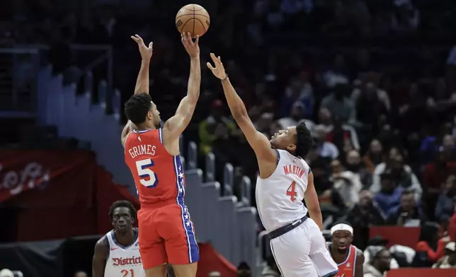 Philadelphia 76ers forward Quentin Grimes (5) shoots the ball over Washington Wizards guard Jaylen Martin (4) during the first half of an NBA basketball game in Washington, Wednesday, April 9, 2025. (AP Photo/Terrance Williams)