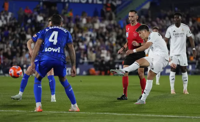 Real Madrid's Arda Guler scores his side's opening goal during a Spanish La Liga soccer match between Getafe and Real Madrid at the Coliseum Alfonso Perez stadium in Getafe, Spain, Wednesday, April 23, 2025. (AP Photo/Manu Fernandez)