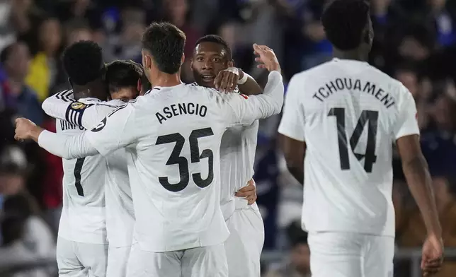 Real Madrid's Arda Guler celebrates with team mates after scoring his side's opening goal during a Spanish La Liga soccer match between Getafe and Real Madrid at the Coliseum Alfonso Perez stadium in Getafe, Spain, Wednesday, April 23, 2025. (AP Photo/Manu Fernandez)