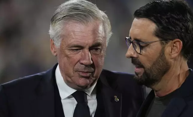 Real Madrid's head coach Carlo Ancelotti, left, and Getafe's head coach Jose Bordalas arrive for a Spanish La Liga soccer match between Getafe and Real Madrid at the Coliseum Alfonso Perez stadium in Getafe, Spain, Wednesday, April 23, 2025. (AP Photo/Manu Fernandez)