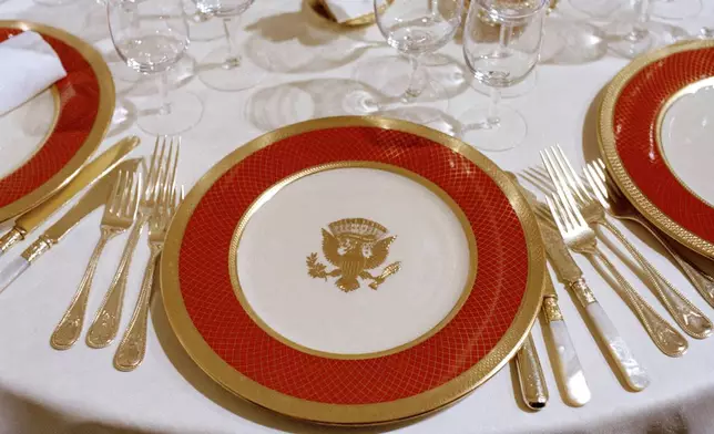 FILE - The new White House china, chosen by first lady Nancy Reagan and purchased for $209,509 through private donations, is unveiled to the press at the White House in Washington, Feb. 3, 1982. The china, as laid out for a state dinner, includes 220 place settings with 4,372 pieces. (AP Photo/Ron Edmonds, File)