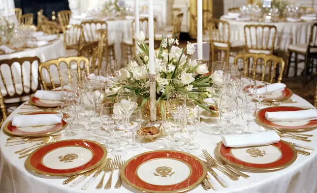 FILE - The new White House china, chosen by first lady Nancy Reagan and purchased for $209,509 through private donations, is unveiled to the press at the White House in Washington, Feb. 3, 1982. The china, as laid out for a state dinner, includes 220 place settings with 4,372 pieces. (AP Photo/Ron Edmonds, File)